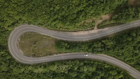 Aerial view drone view on automobile on the road trough the trees in mounta.. Stock Footage 242198301