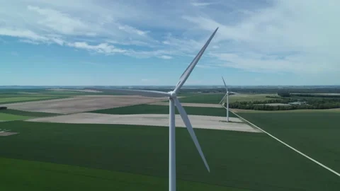 Aerial view by drone of a windmill part of a wind farm showing in the fields Stockbeeldmateriaal 166309792