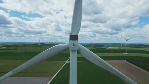 Aerial view by drone of a windmill part of a wind farm showing in the fields Stockbeeldmateriaal 166311156