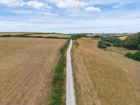 Aerial view of dry yellowing fields and a dirt track in rural Cornwall Fotos de archivo