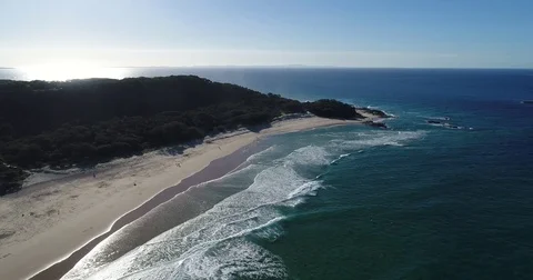 Aerial view of dscending toward waves at the beach Stock Footage 78328095
