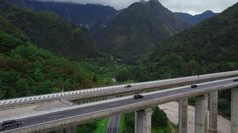 Aerial view of dual elevated bridges crossing mountainous forest valley Video stock 342506692