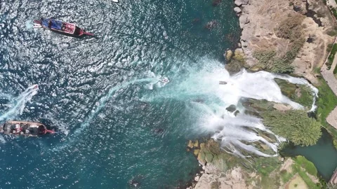 Aerial view of Düden Waterfall falling into Mediterranean sea with cruise ships Stock Footage 342956598