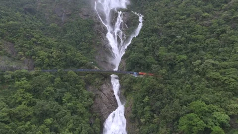 Aerial View of Dudhsagar Waterfall with Train Crossing Bridge in Goa India 動画素材 332886689