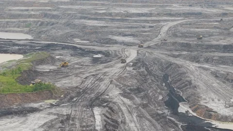 Aerial view of dump truck approaching excavator to load cargo in coal mining Vídeo Stock 332720237