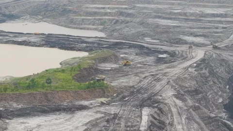 Aerial view of dump truck approaching excavator to load cargo in coal mining Stock Footage 332720265