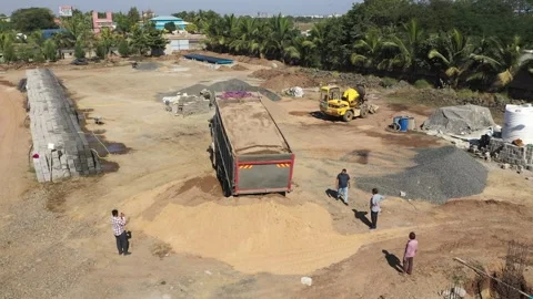 Aerial View of Dump Truck Dumping Load with Workers at Industrial Site. Vídeos de archivo 339097726