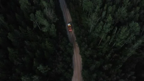 Aerial view to dump truck mooving on a road through forest with sand Stock Footage 163376442