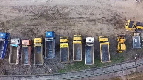 Aerial view of dump trucks and excavators at construction site Stock Footage 346410370