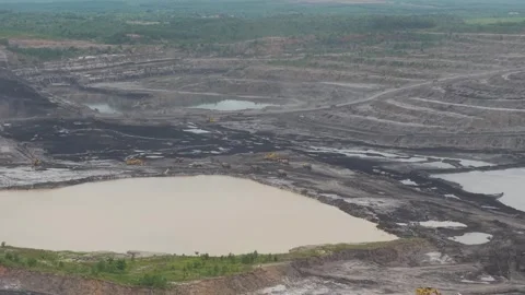 Aerial view of dump trucks queuing in front of an excavator to load coal, c.. Stock Footage 332601122