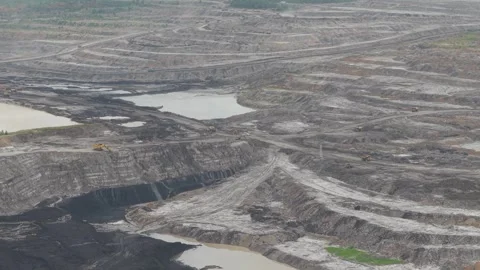 Aerial view of dump trucks queuing in front of an excavator to load coal, c.. Stockbeeldmateriaal 332601598