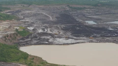 Aerial view of dump trucks queuing in front of an excavator to load coal, c.. Stockbeeldmateriaal 332602361