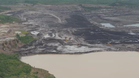 Aerial view of dump trucks queuing in front of an excavator to load coal, c.. Stockbeeldmateriaal 332602365