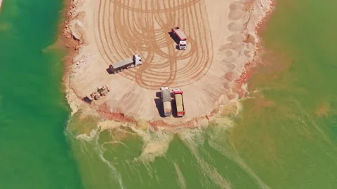 Aerial view of dump trucks working at a quarry site Stock-Footage 345007348