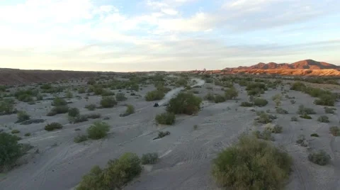Aerial view of dune buggy driving through desert into the sunset with lens flare 動画素材 58742879