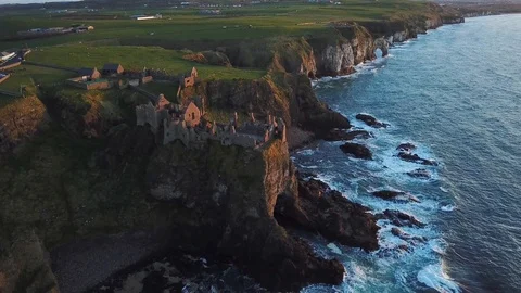 Aerial view of Dunluce castle on a cliff during sunset, Northern Ireland Stock Footage 89871129