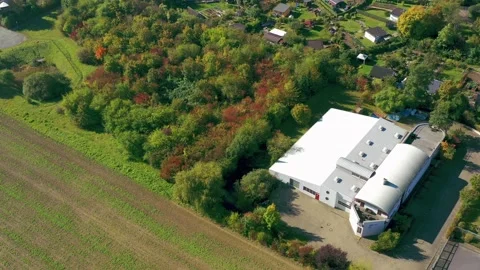 Aerial view during a reverse flight of a modern small warehouse Stock Footage 162798380