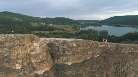 Aerial view on during romantic stroll guy shows girl finger into the distance on Stock Footage 97905247