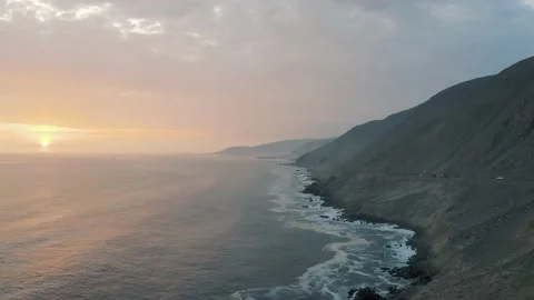 Aerial view during sunset of Pacific Ocean, the coast in Peru 4K Stock Footage 197280175