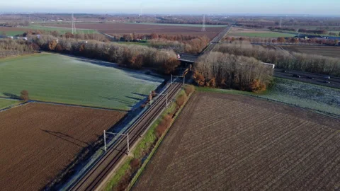 Aerial View of Dutch Train Traversing Frozen Meadow Stock-Footage 241113462