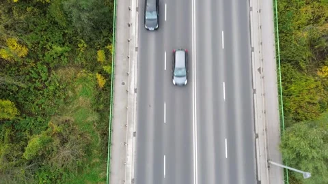 Aerial view of a dynamic car ride along a busy highway, showcasing vehicles in Stock Footage 335892468