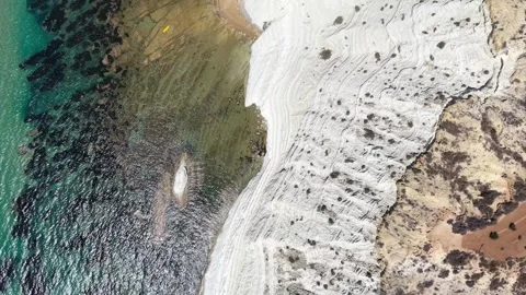 Aerial view of dynamic sea waves crashing against white cliffs Stock Footage 345149226