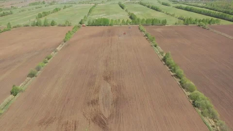 Aerial view of earthen fields ready for sowing using machinery Stock Footage 160125406