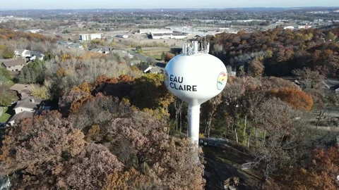 Aerial view of Eau Claire, Wisconsin, water tower, and surrounding urban area. Stock Footage