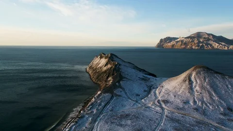Aerial view on the edge of the mountain coast in Greenland. Aerial view on snow Stock Footage 102276216