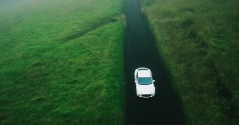 Aerial view electric car driving on country road Stock Footage