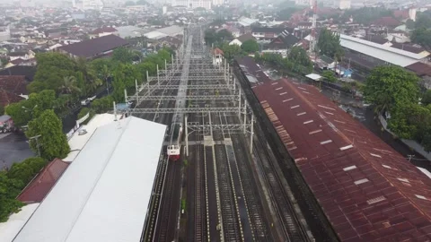 Aerial view of electric passenger train moving along multiple railroad trac.. Stock Footage 337275455