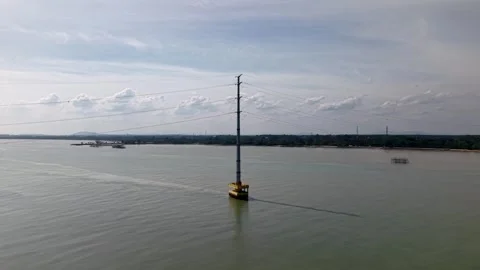 Aerial view of electric pole with power lines in river water Stock Footage 336816890