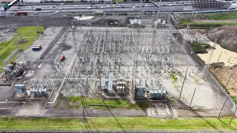 Aerial view of electrical substation and highway traffic Stock Footage 342327316