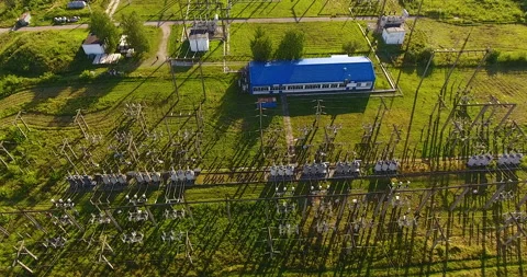 Aerial view on electrical substation with a big building and transformers 스톡 동영상 171358344