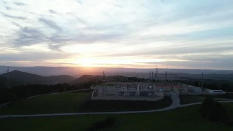 Aerial view of electrical substation in rural landscape at sunset Stock Footage 327273048