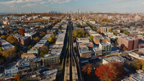 Aerial view of elevated train tracks through Brooklyn neighborhood, ProRes 422HQ Stock Footage 331353248