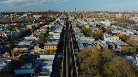 Aerial view of elevated train tracks through Brooklyn neighborhood, ProRes 422HQ Stock Footage 331354205
