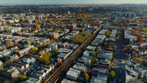 Aerial view of elevated train tracks through urban neighborhood, ProRes 422HQ Stock Footage 331355237