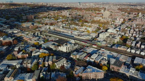 Aerial view of elevated train tracks through urban neighborhood, ProRes 422HQ Stock Footage 331356094