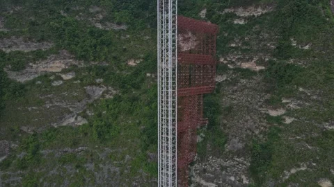 Aerial view of elevator construction on a tropical cliff Stock Footage 327817508