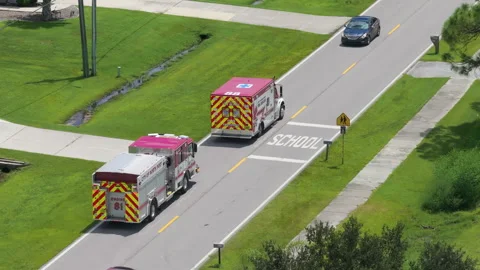Aerial view of emergency scene outside suburban home with first responders on Stock Footage 325938542