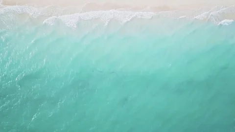 Aerial view of empty beach and turquoise sea, with umbrellas and sun loungers Stock Footage 111821944