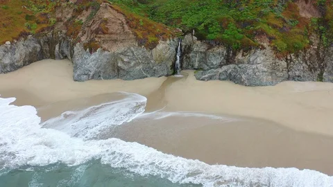 Aerial View of Empty Beach and Small Waterfall on Northern California Coast Video stock 128658060