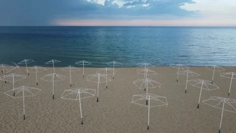 Aerial View of an empty beach with beach umbrellas. Video stock 195099185