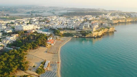 Aerial view of the empty beach, city and the sea at sunrise Stock Footage 111875903
