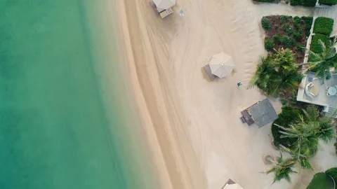 Aerial view of an empty beach with white parasol, U.A.E. Stock Footage 103032201