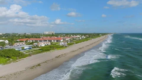 Aerial view of empty city beach with ocean waves and variety of hotels with Stock Footage 258403341