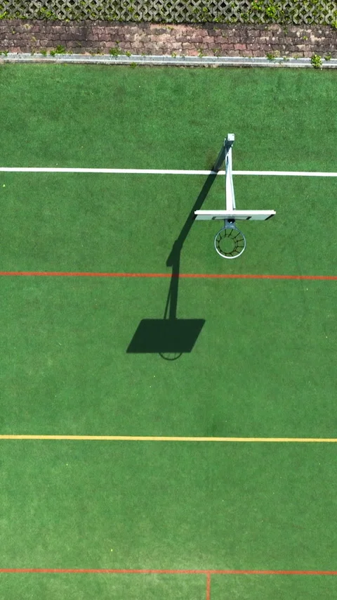 Aerial View of Empty Green Basketball Court with Hoop Shadow Stock Footage 339229691