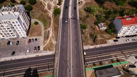 Aerial view of an empty highway bridge surrounded by green fields, trees, and Stock Footage 279651977