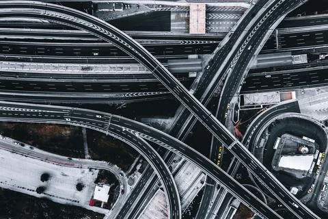 Aerial view of an empty intersection with crossing roads and few cars Stock Photos